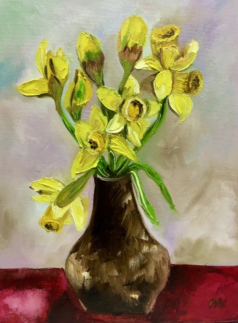 Daffodils in a Vase on Red Table. 