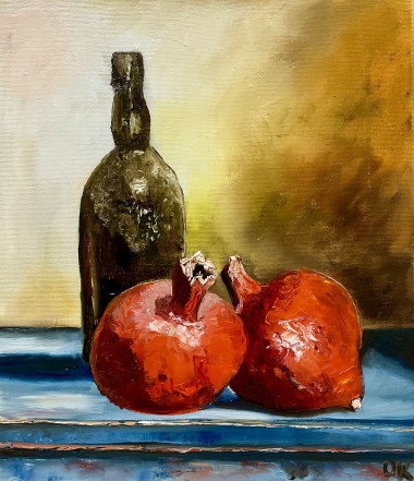 Two pomegranates and a bottle 